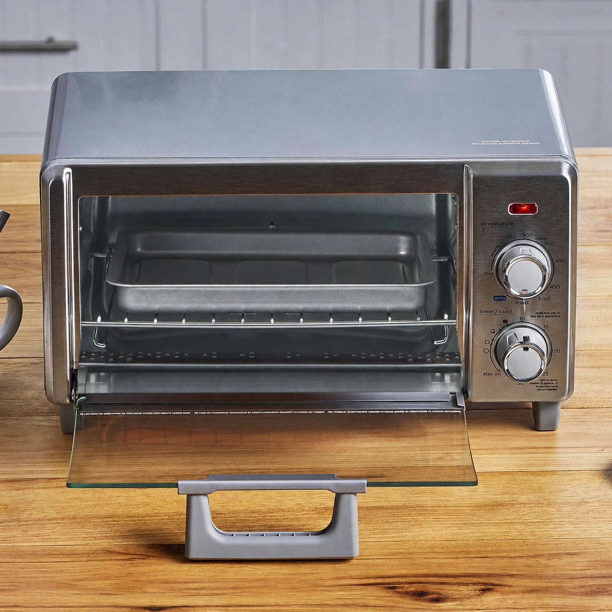 Stainless-steel five-in-one countertop toaster oven with its glass door open